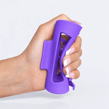 Main tenant la pince Cushy NOVELIA, format ergonomique anti-glissement pour cheveux épais